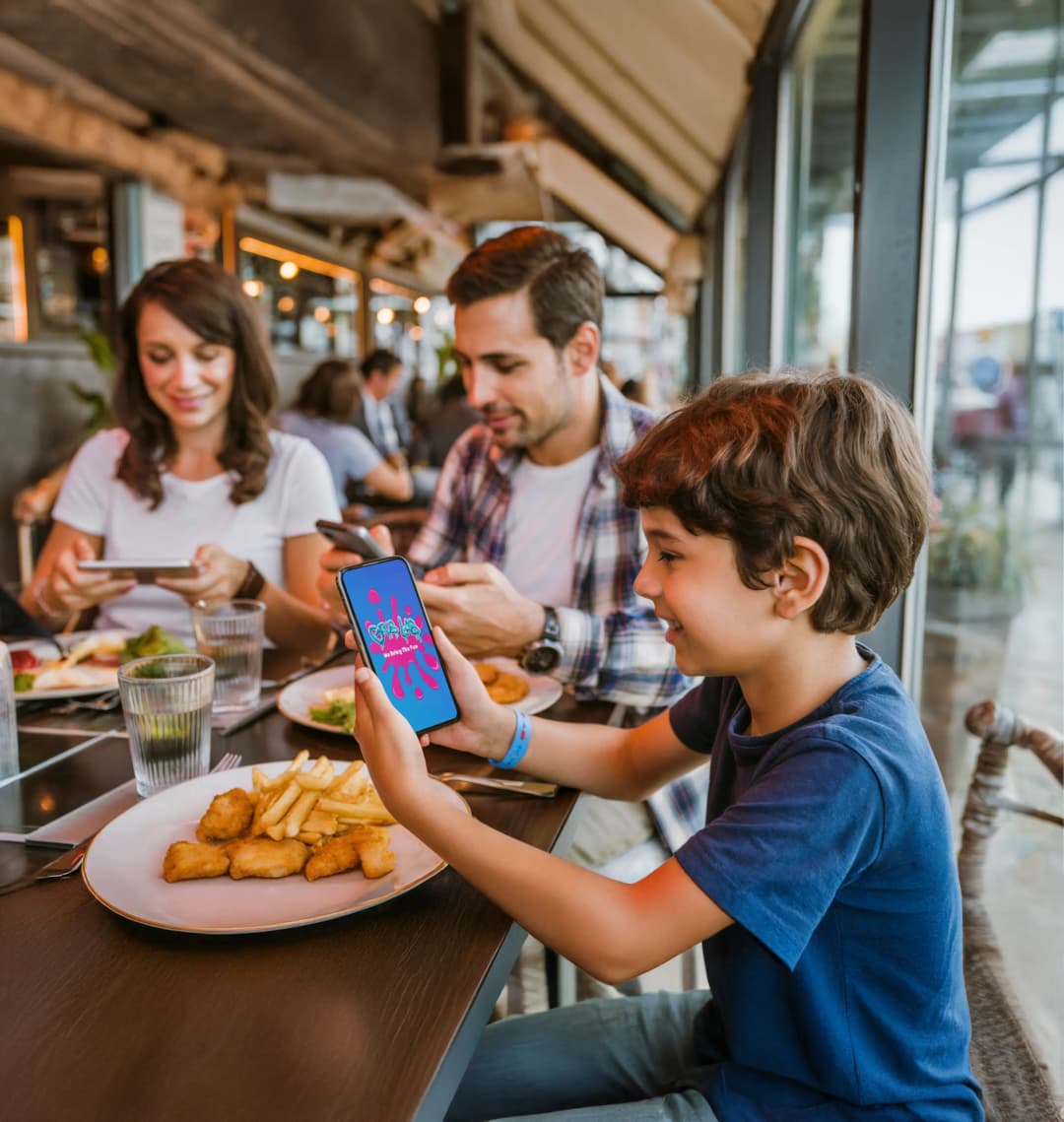 Happy child enjoying interactive games with Grub Lab menu at restaurant